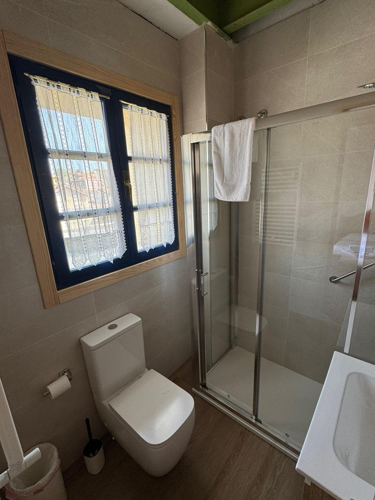 Baño privado con ducha y ventana azul Hotel Cuevas del Mar Llanes Asturias